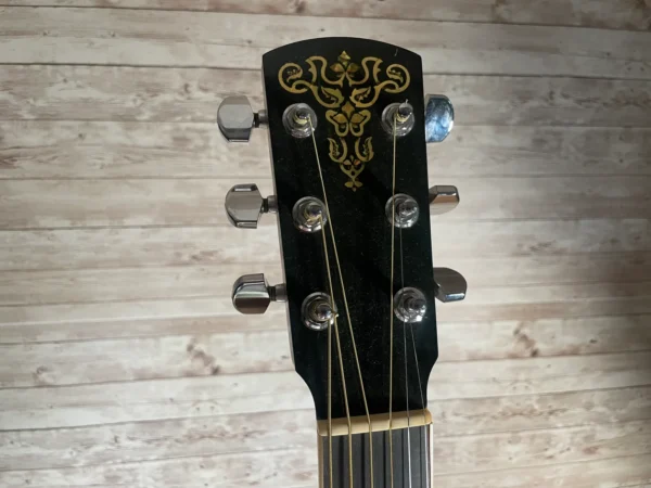 Stunning Made in Canada Jumbo acoustic. 1995. Solid cedar top with ornate koa back and sides. Very nice rosette and beautiful inlays on the fingerboard, and check out that headstock! Large, rich and loud tone with Fishman electronics. Some light general wear throughout as pictured, but nothing significant. Playing great with a fresh setup. Includes original hardshell case.