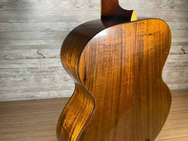 Stunning Made in Canada Jumbo acoustic. 1995. Solid cedar top with ornate koa back and sides. Very nice rosette and beautiful inlays on the fingerboard, and check out that headstock! Large, rich and loud tone with Fishman electronics. Some light general wear throughout as pictured, but nothing significant. Playing great with a fresh setup. Includes original hardshell case.