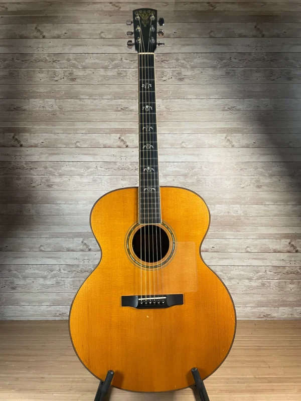 Stunning Made in Canada Jumbo acoustic. 1995. Solid cedar top with ornate koa back and sides. Very nice rosette and beautiful inlays on the fingerboard, and check out that headstock! Large, rich and loud tone with Fishman electronics. Some light general wear throughout as pictured, but nothing significant. Playing great with a fresh setup. Includes original hardshell case.