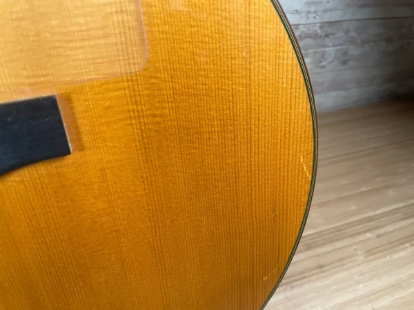 Stunning Made in Canada Jumbo acoustic. 1995. Solid cedar top with ornate koa back and sides. Very nice rosette and beautiful inlays on the fingerboard, and check out that headstock! Large, rich and loud tone with Fishman electronics. Some light general wear throughout as pictured, but nothing significant. Playing great with a fresh setup. Includes original hardshell case.