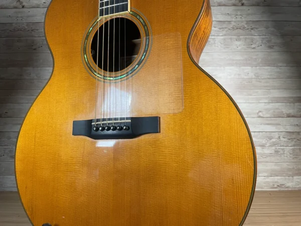 Stunning Made in Canada Jumbo acoustic. 1995. Solid cedar top with ornate koa back and sides. Very nice rosette and beautiful inlays on the fingerboard, and check out that headstock! Large, rich and loud tone with Fishman electronics. Some light general wear throughout as pictured, but nothing significant. Playing great with a fresh setup. Includes original hardshell case.